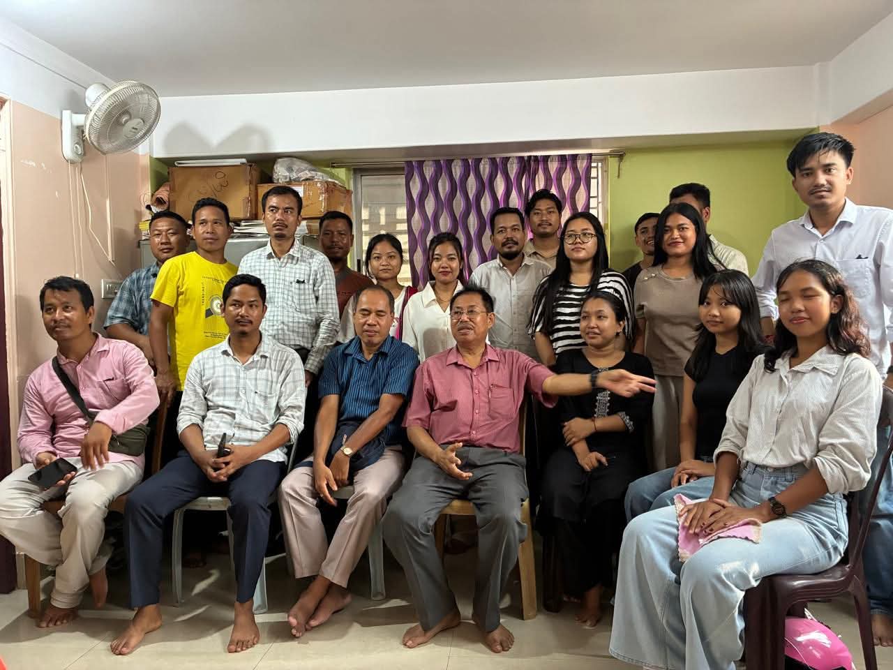 A group photograph of association members indoors.